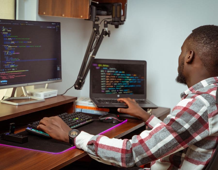Young professional working at a dual-screen desk